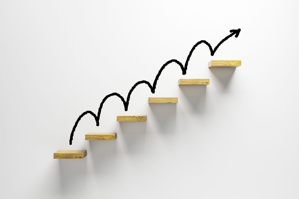 Wooden staircase six steps with upward arrow on white background